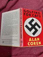 Book titled 'Golfing for Cats' by Alan Coren with a red cover featuring a black swastika symbol on a red background.