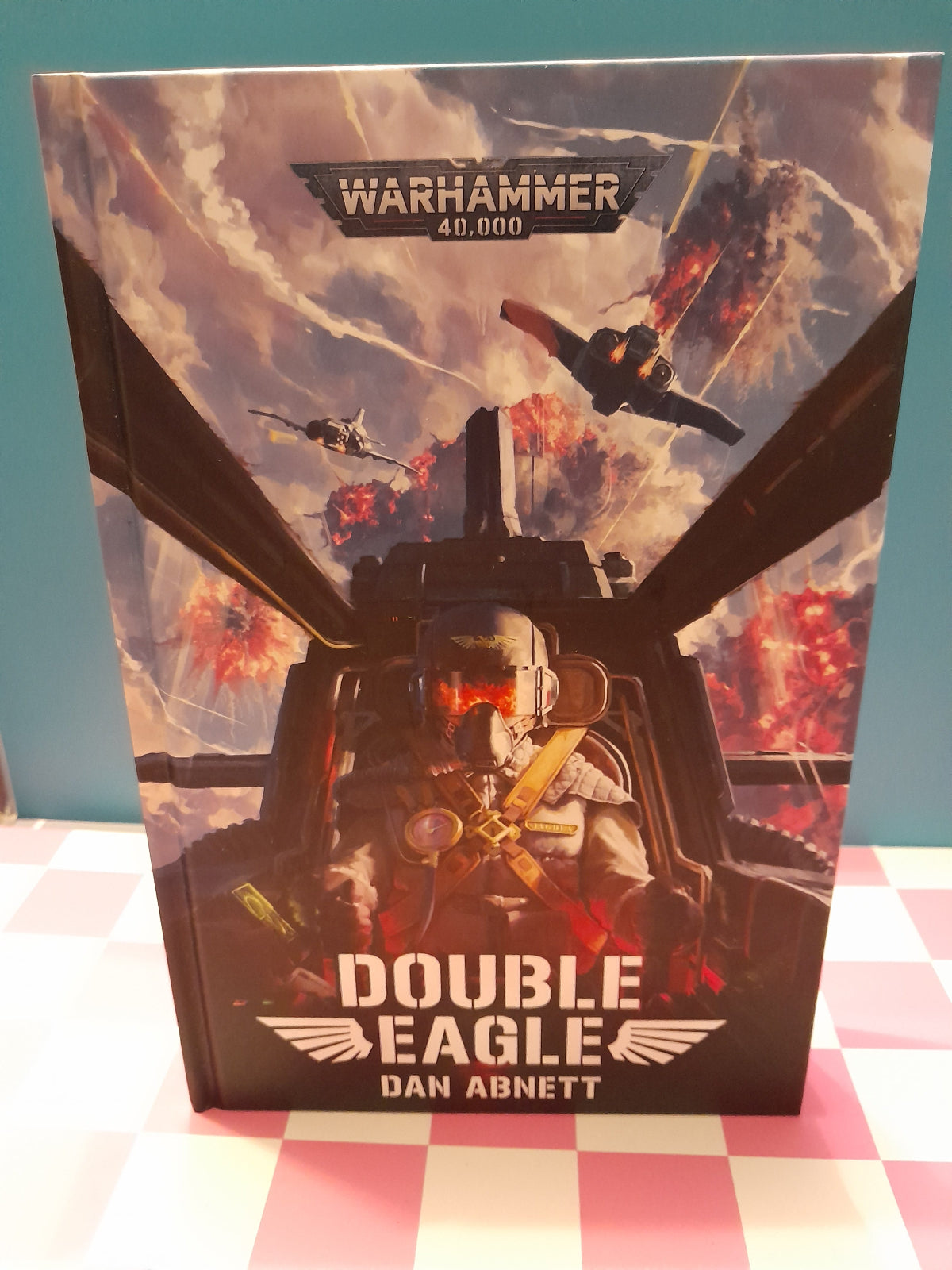 Book titled 'Double Eagle' by Dan Abnett with Warhammer 40,000 cover art on a checkered background
