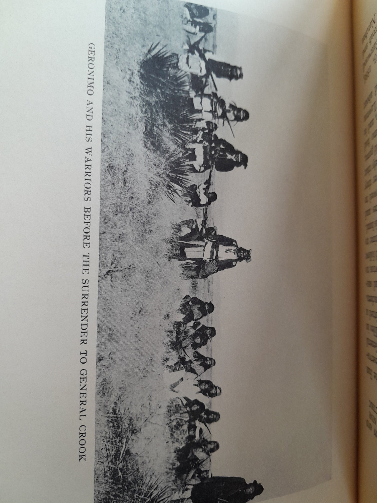 Black and white illustration of Geronimo and his warriors before surrender, with text on a book page.