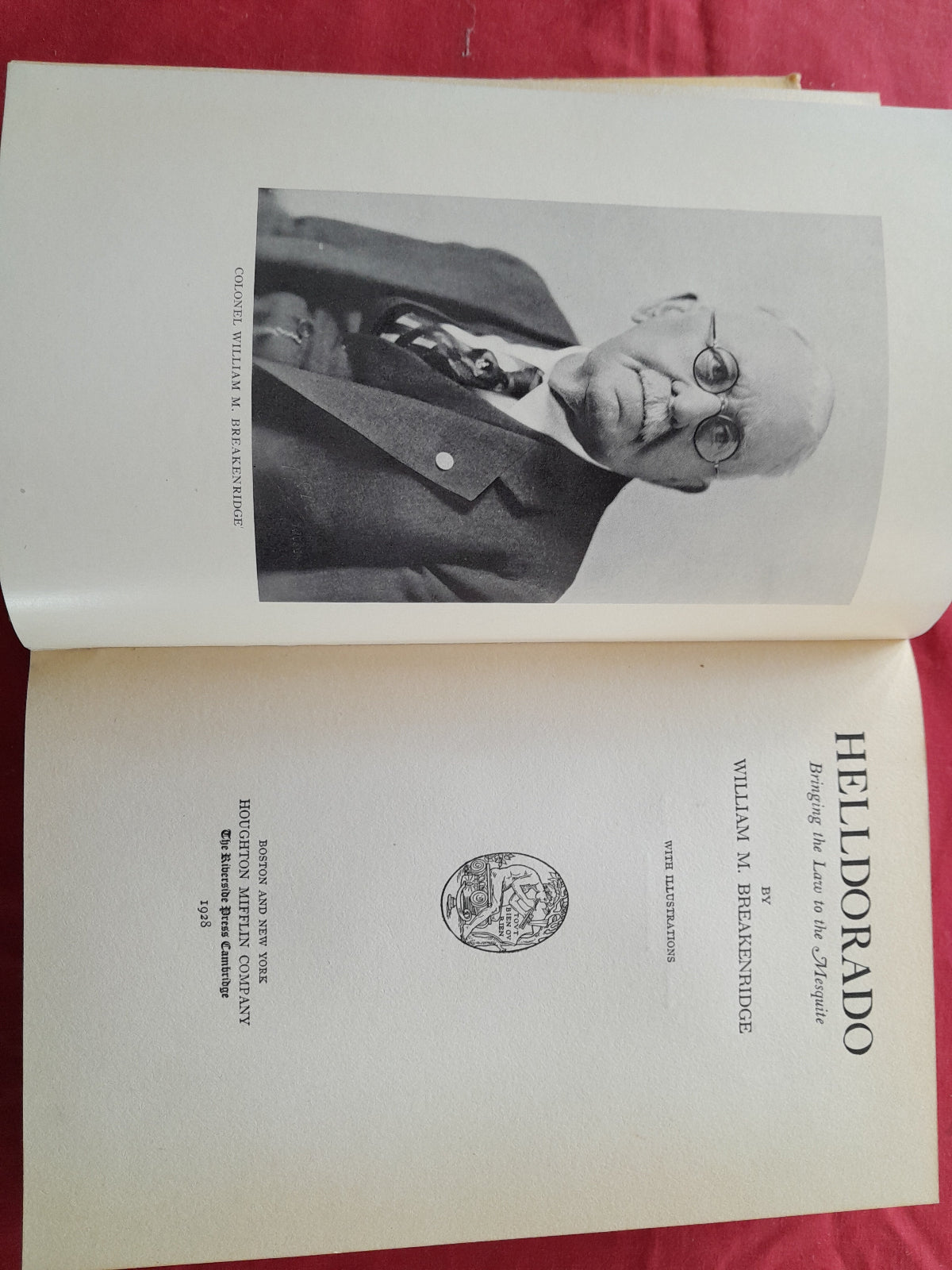 Open book with a portrait and title page of 'Helldorado' by William M. Breakenridge on a red background.