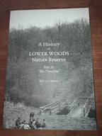 Book titled 'A History of Lower Woods Nature Reserve Part II' on a wooden surface