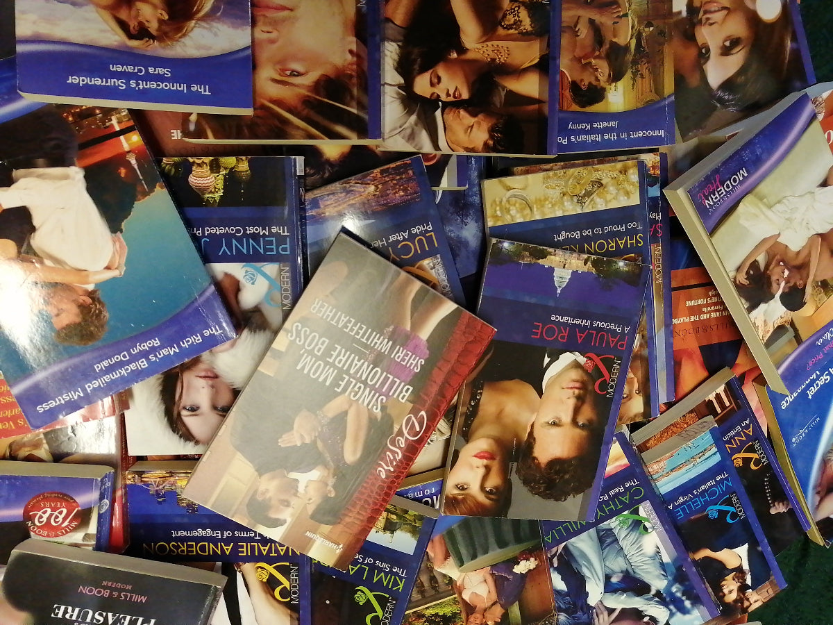 Collection of romance novels with various covers featuring couples in intimate poses.
