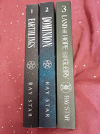 Three books titled 'Land of Hope and Glory', 'Dominion', and 'Earthlings' by Ray Star on a red fabric background.