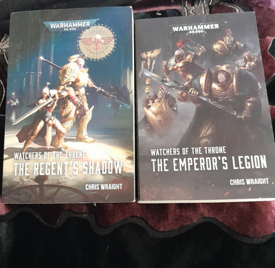 Two books titled 'The Emperor's Legions' and 'The Reaper's Shadow' by Chris Wraight on a textured surface.