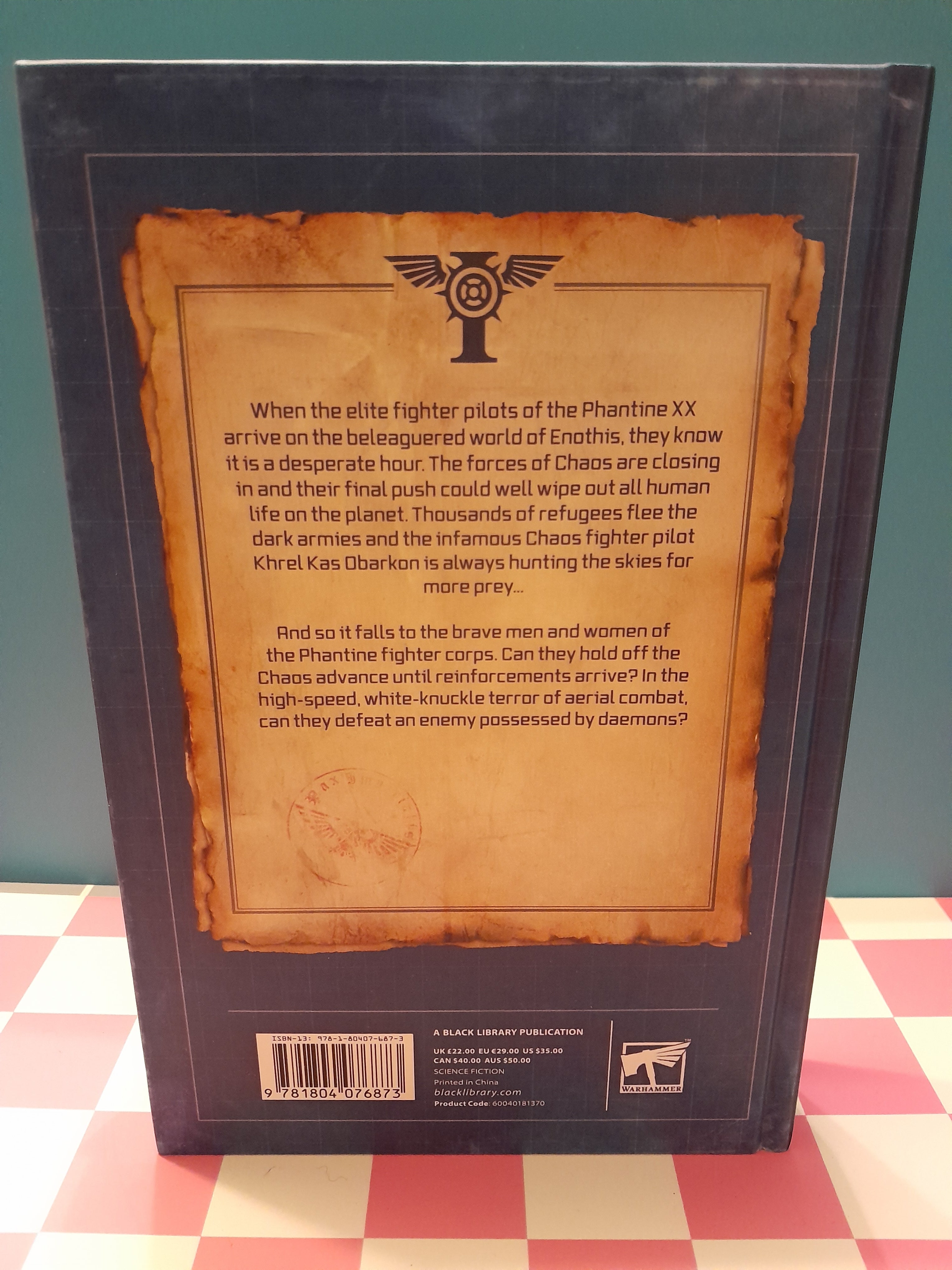 Back cover of a book with text and logos on a checkered floor background